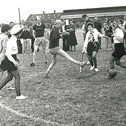 Workers playing hockey in fancy dress