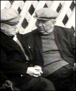 two men sitting on the promenarde