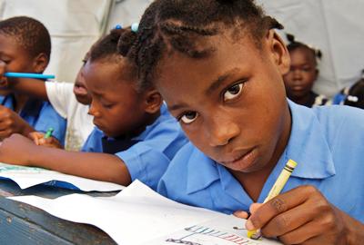 Haitian school day starts school again after the earthquake in a UNICEF temporary school photo copyright UNICEF used with permission