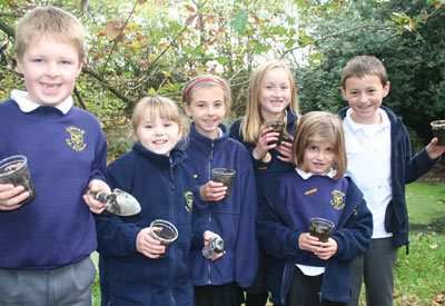Group of Cudham primary pupils with pond mud